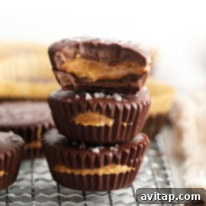 stacked almond butter cups with a recipe card title