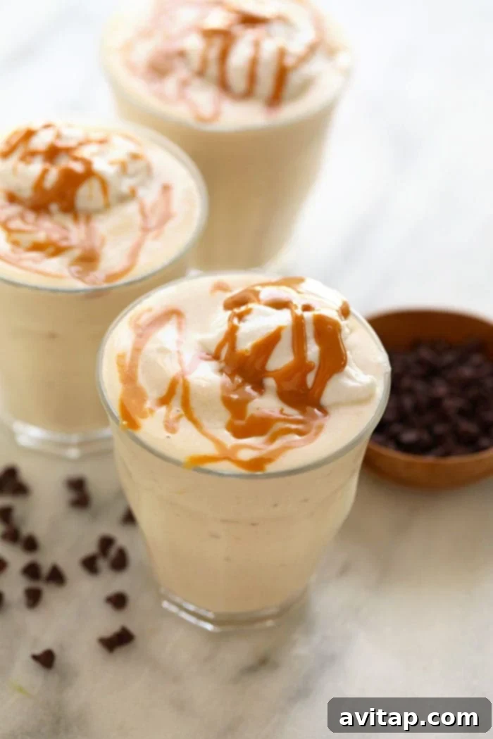 This Healthy Banana Protein Shake is packed with a short list of real ingredients and blended together to perfection! Boasting 16 g of protein per serving and oh so flavorful, this protein shake recipe will fuel your body post-workout or or as a sweet treat. Enjoy! A beautifully garnished healthy banana protein shake in a glass, topped with peanut butter drizzle and whipped coconut milk, ready to be enjoyed.
