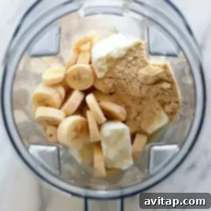 A blender filled with bananas and other ingredients, creating a delicious banana protein shake.