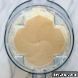 A food processor filled with a mixture of banana protein shake ingredients.