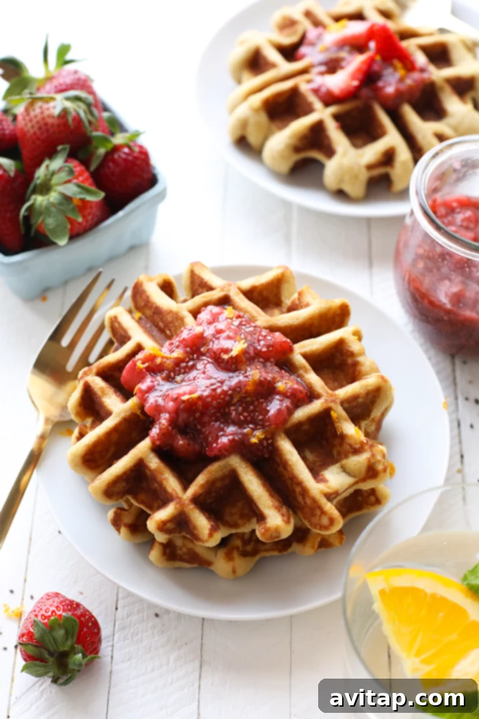Waffles with a vibrant strawberry chia compote on a plate, ready to be enjoyed for a delicious gluten-free breakfast.