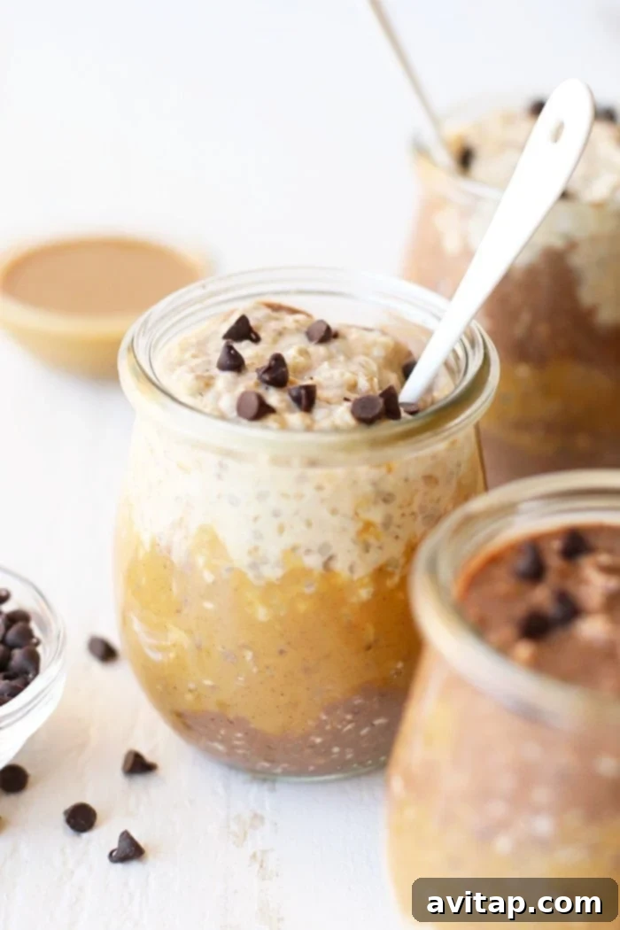 A close-up of the smooth, creamy texture of layered peanut butter and chocolate overnight oats.