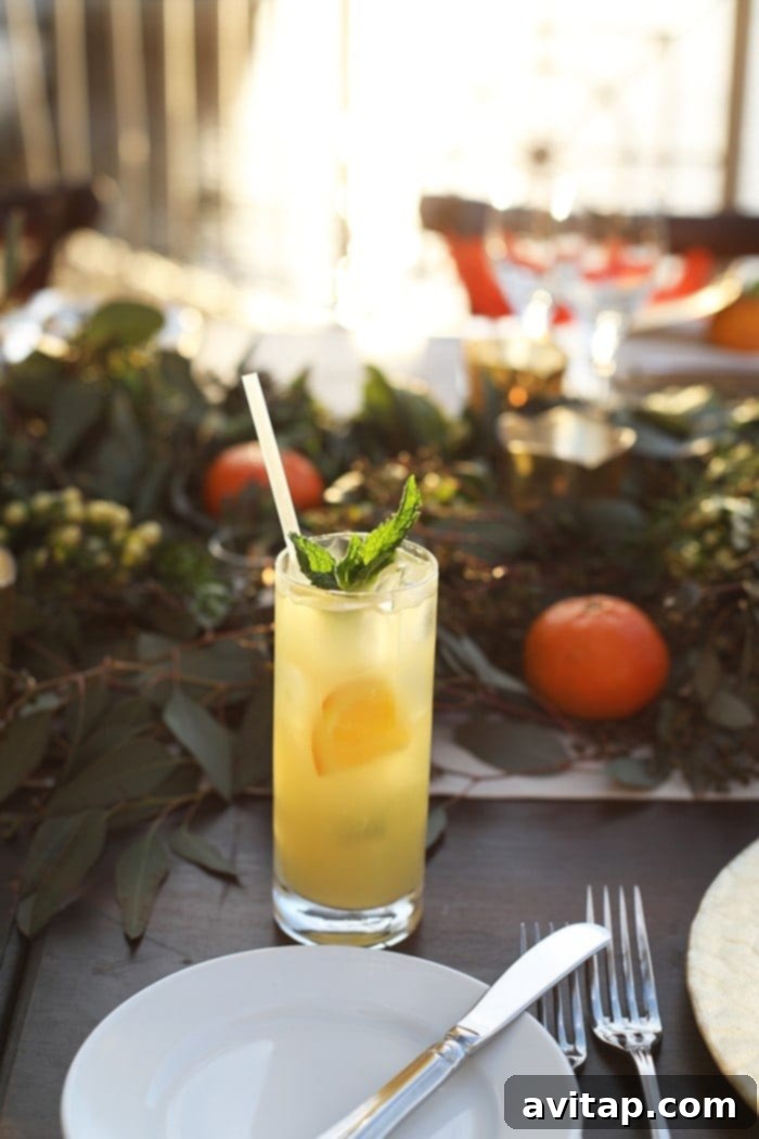 Close-up of the elegant orange and greenery table decor at the Ritz-Carlton dinner.