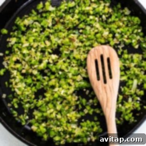 Green onions and bell pepper cooking in skillet.