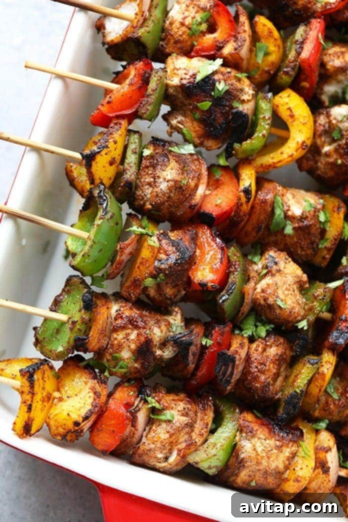 chicken fajita kabobs in casserole dish.