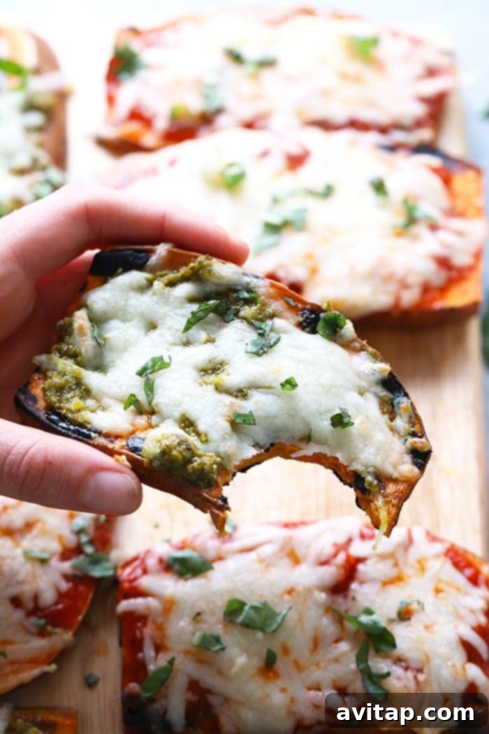 Fire-Kissed Sweet Potato Pizzas 4 Three perfectly grilled sweet potato pizza slices on a cutting board, topped with marinara, mozzarella, and basil.