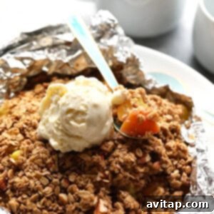 Peach season is here and this foil-pack peach crumble recipe on the grill is easy, delicious, and healthy! It's made with juicy peaches tossed in maple syrup and a yummy crumble topping, making it a gluten free fruit crumble and a healthy dessert recipe for the summertime!