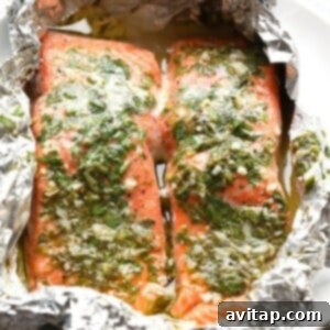 Grilled salmon in foil pack with herbs and butter, showcasing a healthy and flavorful meal.