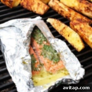 Grilled salmon in foil on a grill.