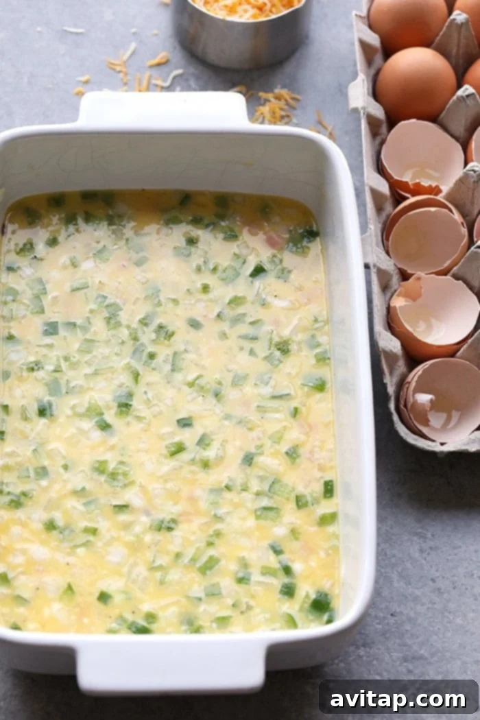 Denver Omelet Casserole 4 A vibrant slice of Denver Omelette Egg Bake showing a medley of colorful ingredients.
