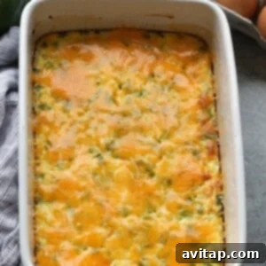Melted cheese topping a golden-brown Denver Omelette Egg Bake in a casserole dish.