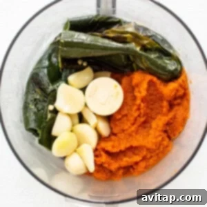 Hearty Pumpkin Chili 5 Roasted ingredients and pumpkin puree being blended in a food processor.