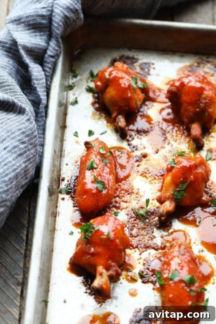 Healthy baked chicken wings arranged neatly on a baking sheet, showcasing their golden-brown, crispy skin.