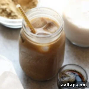 A protein drink in a mason jar filled with cold brew coffee and a straw, ready to drink.