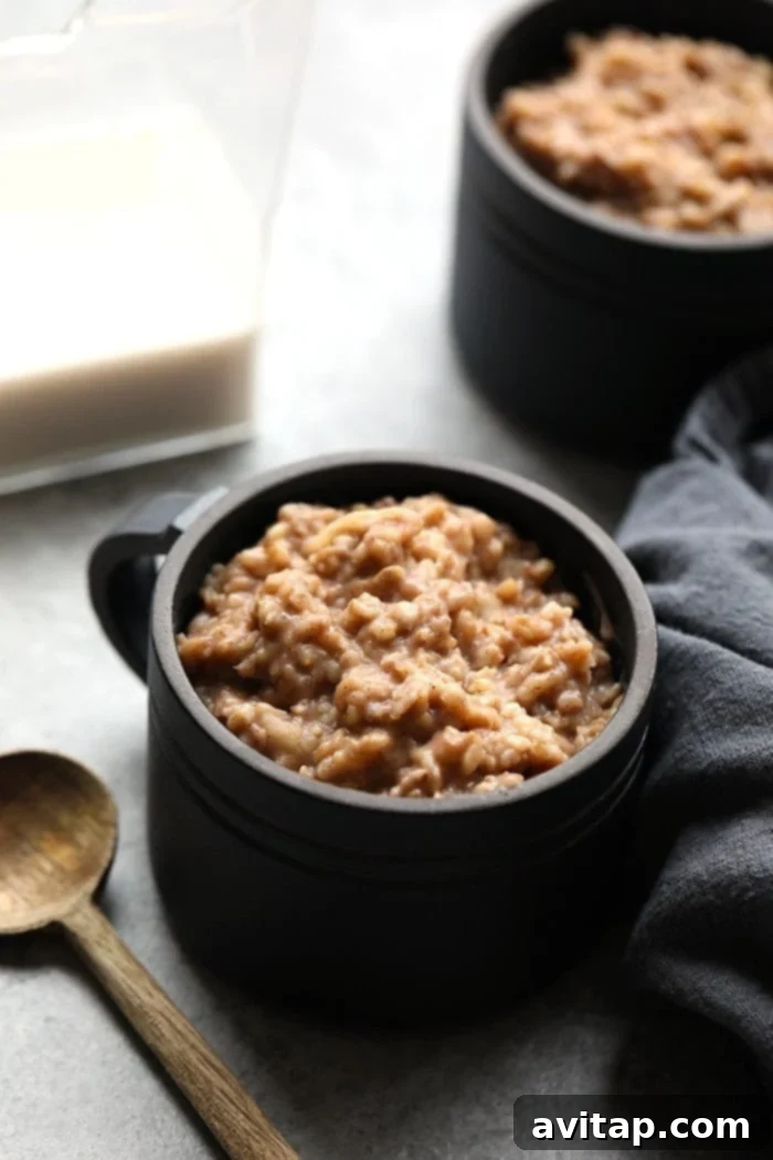 Delicious slow cooker apple cinnamon oatmeal in a cup, ready to serve for a healthy breakfast.