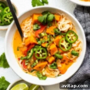 A perfectly portioned bowl of the delicious coconut curry soup, garnished with fresh herbs and a hint of spice, ready to be served.