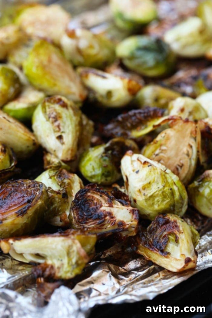 Grilled Brussels Sprouts on tin foil, beautifully charred and seasoned.