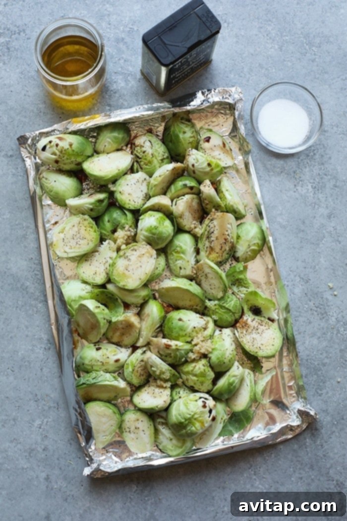 Brussels sprouts expertly cooked on tin foil, showcasing the perfect char.