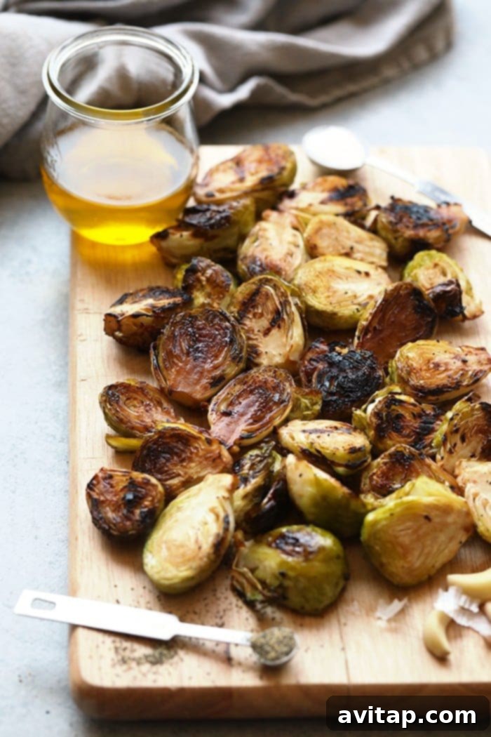 Fresh Brussels sprouts neatly arranged on a cutting board, ready for preparation.