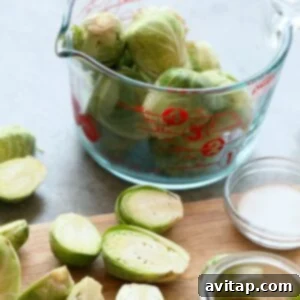 Diced Brussels sprouts on a cutting board, prepared for cooking.