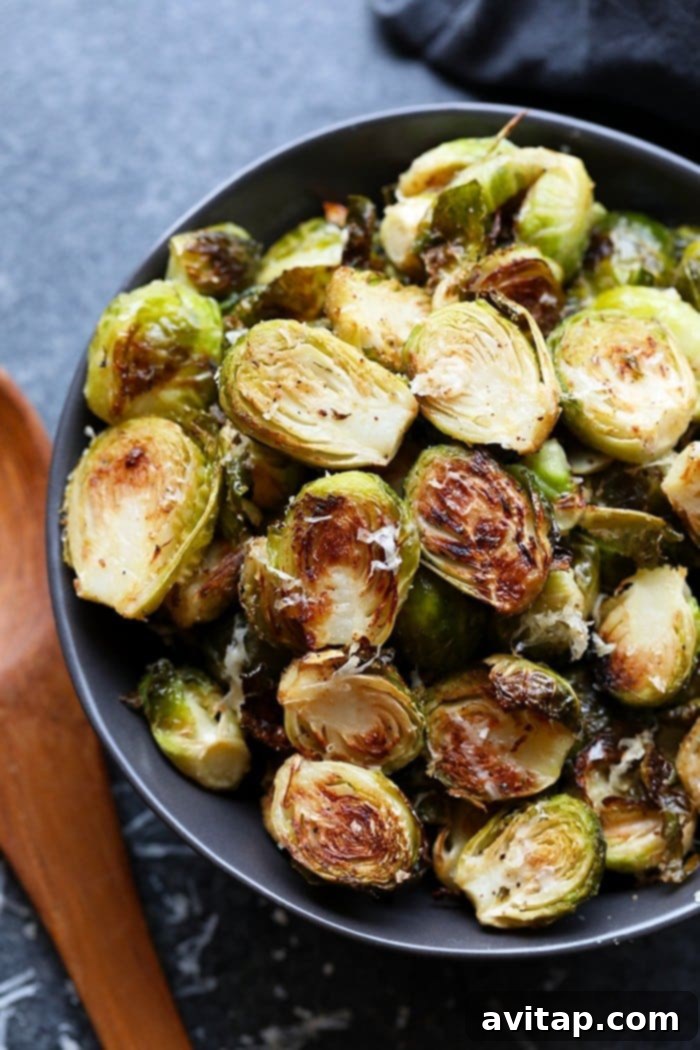 These roasted Brussel sprouts with parmesan are a great side dish staple for any time of year! All you need are 6 ingredients in order to make these crunchy, cheesy bites of heaven. A bowl of fresh, raw Brussels sprouts, ready to be prepared.