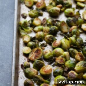 Crispy Parmesan Brussels Sprouts 3 Roasted brussels sprouts with parmesan on a baking sheet.