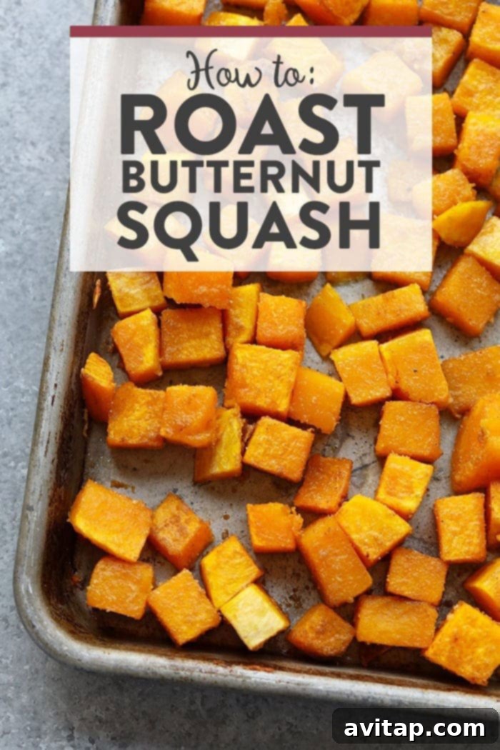 Beautifully roasted butternut squash cubes on a baking sheet, ready to serve.