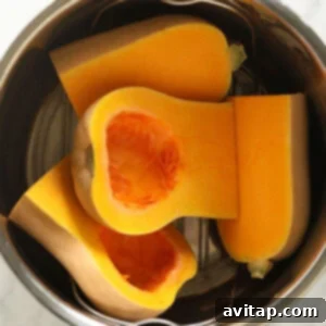 Instant Pot Butternut Squash cooked in a stainless steel pot, perfectly tender.