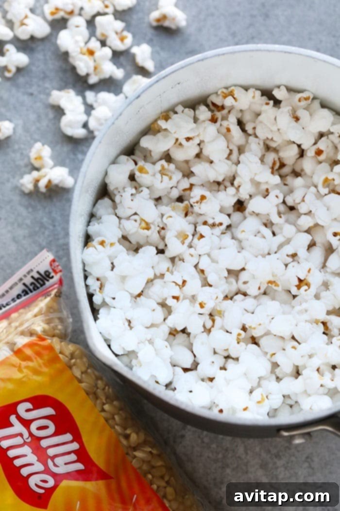 Freshly popped popcorn ready in a large pot, steaming gently and perfectly golden.