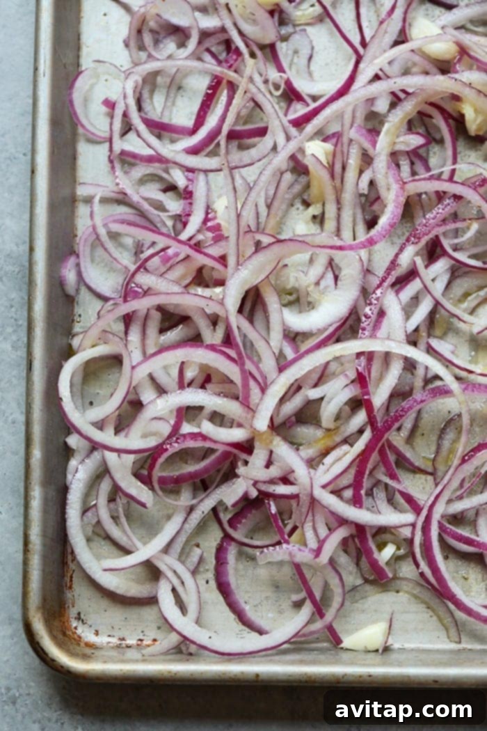 Oven Caramelized Onions 5 Caramelizing onions in the oven, showing the onions starting to soften and brown
