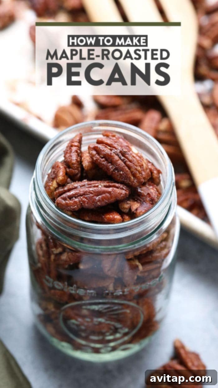 A glass jar filled with golden brown maple roasted pecans, ready for snacking or gifting.