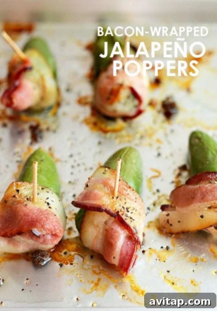 Bacon-wrapped jalapeño poppers on a baking sheet, ready to serve.
