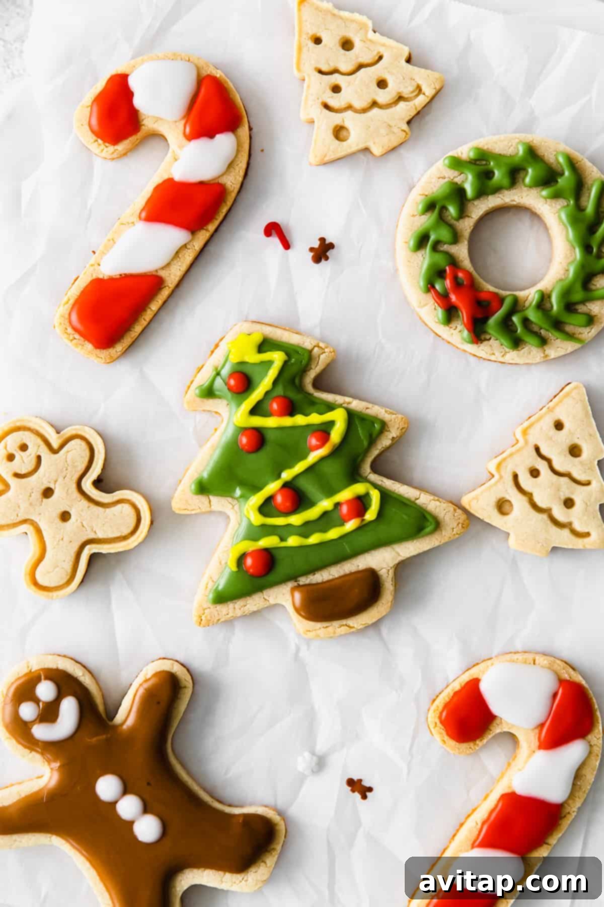 Beautifully decorated Christmas almond flour sugar cookies on a baking sheet, ready for holiday festivities.