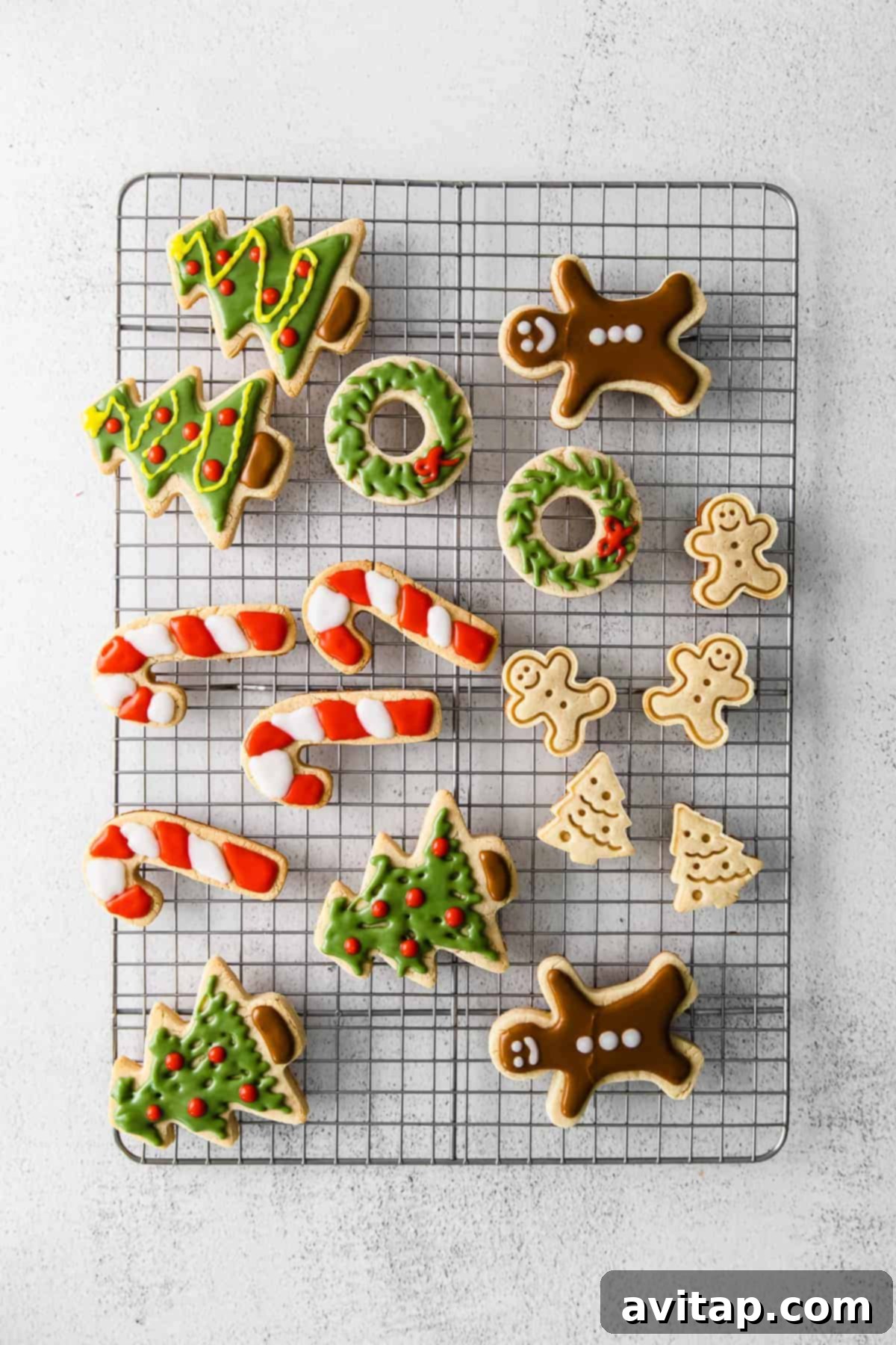 Decorated Christmas almond flour sugar cookies cooling on a wire rack.