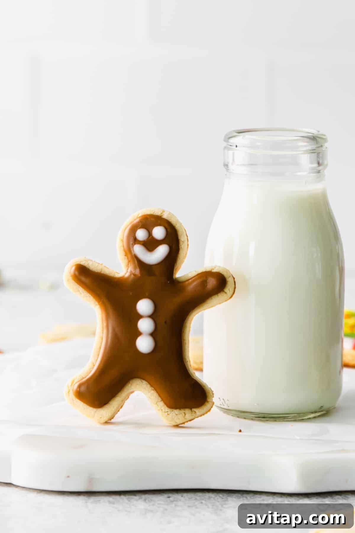 Sugar-free almond flour cookies arranged next to a glass of milk, a perfect healthy holiday treat.