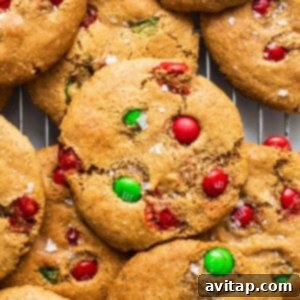 Christmas cookies with M&Ms on a cooling rack, vibrant and inviting.