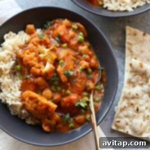 Cauliflower tikka masala curry with rice and naan.