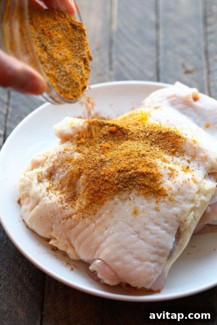 Applying dry rub to chicken thighs before pressure cooking