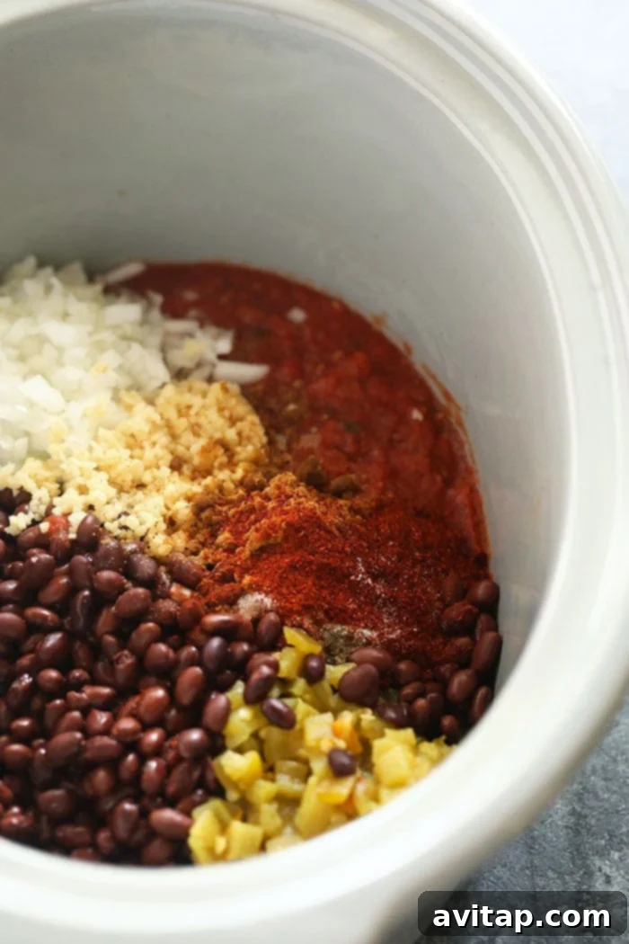 Slow Cooker Black Bean Soup Before Blending The Slow Cooker Black Bean Soup simmering gently in a crock pot, showcasing the rich colors and textures of the ingredients before blending.