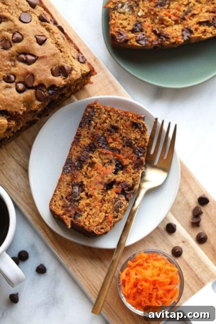 A delectable slice of healthy banana carrot bread, revealing its moist texture and chocolate chips.