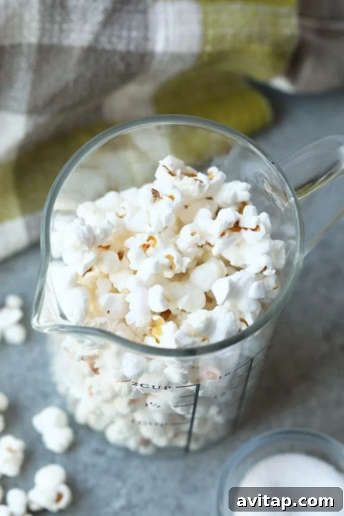 Close-up of a bowl of fluffy, white stovetop popcorn, ready for toppings