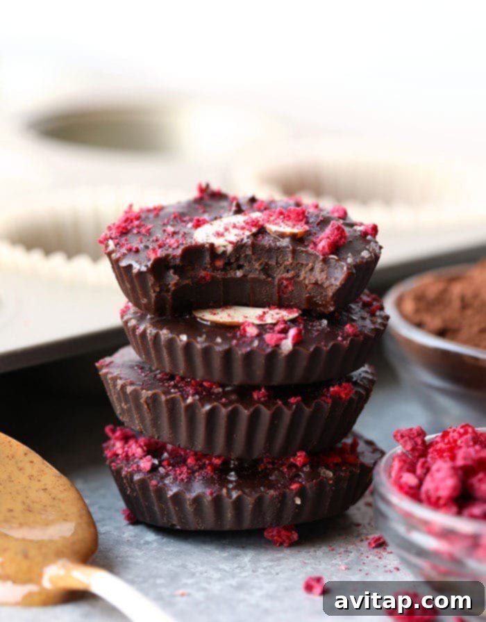 stack of chocolate almond butter cups with fresh raspberries