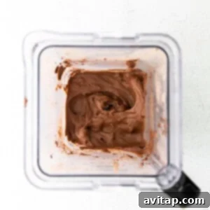 Smooth, blended protein ice cream mixture inside the blender, showing its thick and creamy texture.