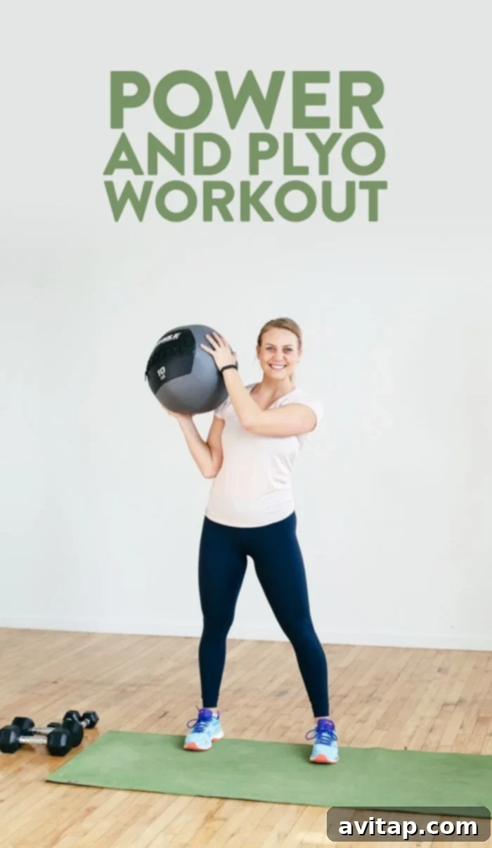 Woman performing a plyometric jump during a power and plyo workout.