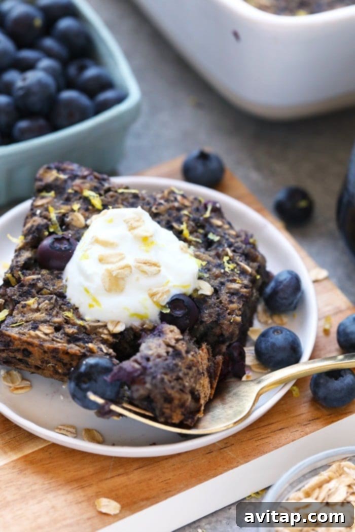 Close-up of baked oatmeal on a plate with fresh lemon and blueberries