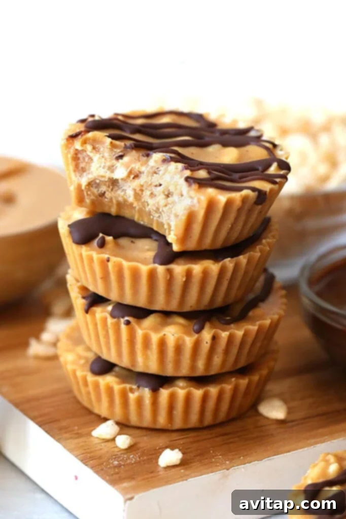 A stack of golden peanut butter crunch cups on a rustic wooden cutting board, showcasing their perfect shape and inviting texture. They appear ready to be enjoyed.