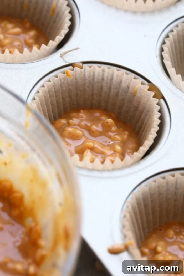 A close-up shot of several crunchy peanut butter cups, perfectly arranged and ready to be served. Each cup showcases its smooth top and a hint of the crispy texture within.