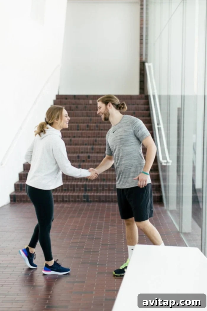 I've totally been that girl who felt shame and stress over wanting to live an active lifestyle when her significant other did not. Today my partner and I have very similar views when it comes to exercise and it's the best thing ever. Here's why... A couple sharing a unique handshake after a workout, symbolizing their shared fitness journey.