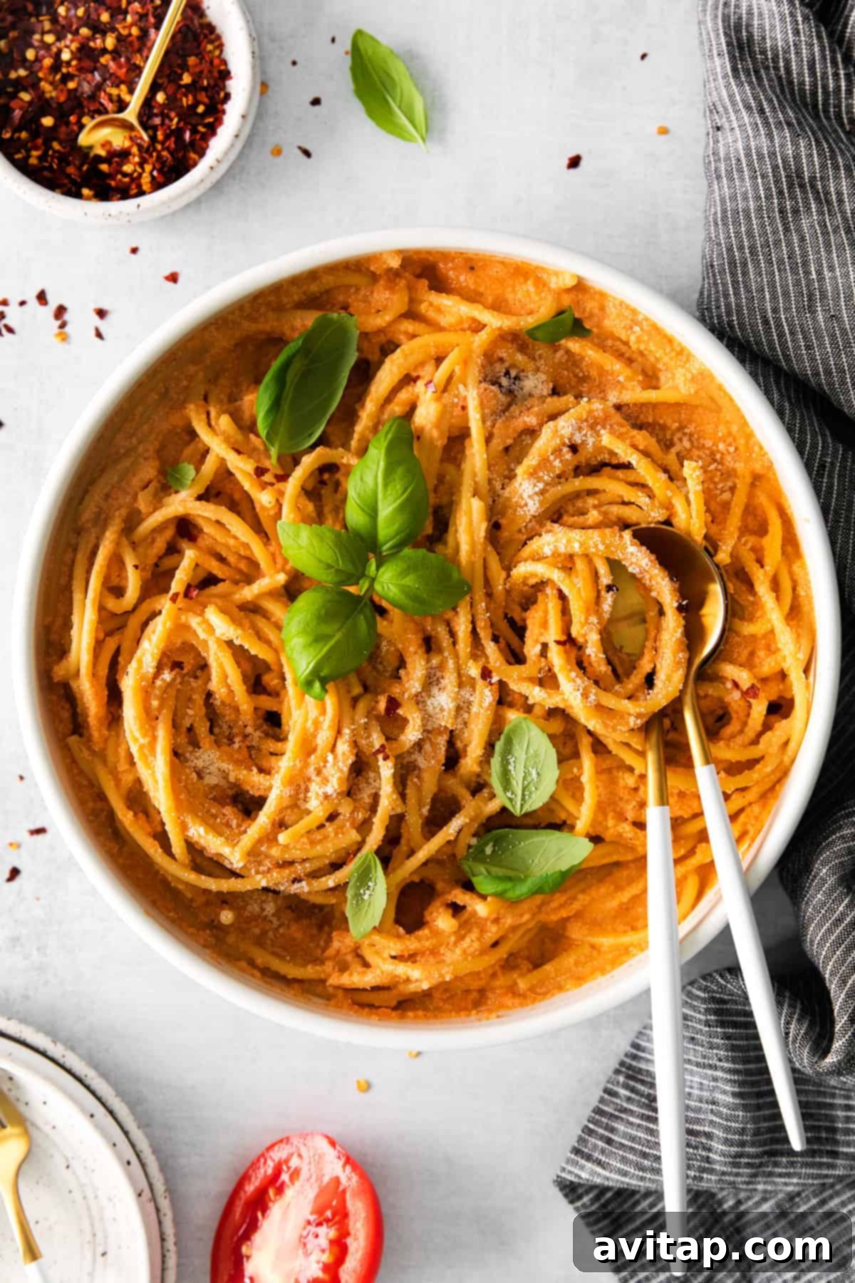 creamy vegan pasta in a bowl garnished with fresh basil
