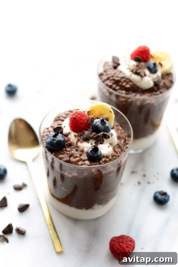 Chocolate chia seed pudding served in a clear glass cup, topped with fresh fruit.